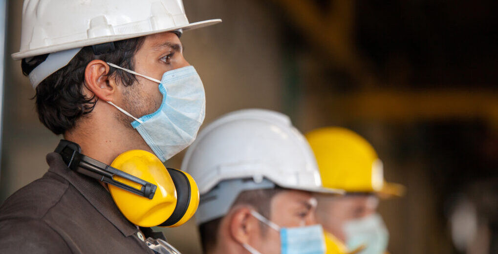 Workers wear protective face masks for safety in machine industrial factory - James & Lindsay Ltd